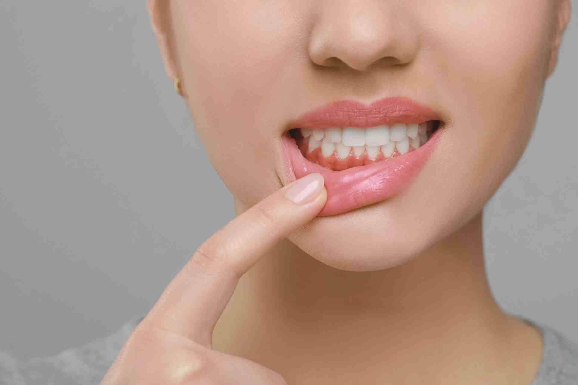 Woman Showing Healthy Gums on Grey Background, Closeup.